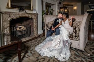 Bride and Groom happy in reception of hotel on a sofa - Wedding Photography in Harrogate