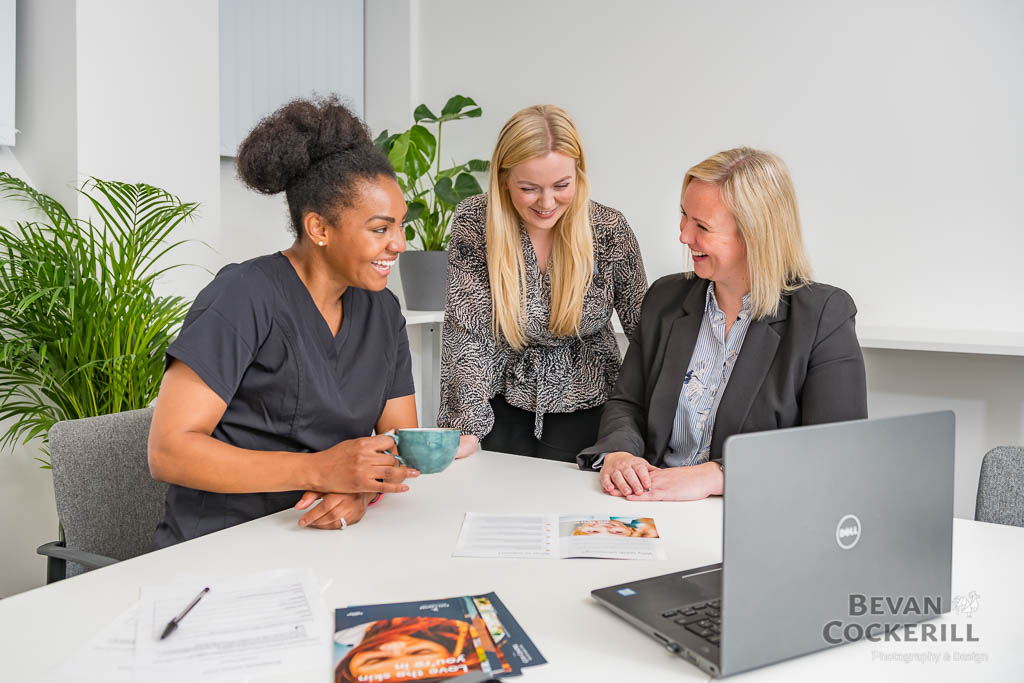Staff gathering for coffee around a table